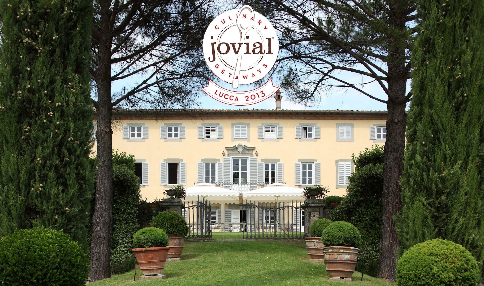 Jovial logo reading CULINARY GETAWAYS jovial LUCCA 2013 over a yellow Italian villa framed by cypress trees