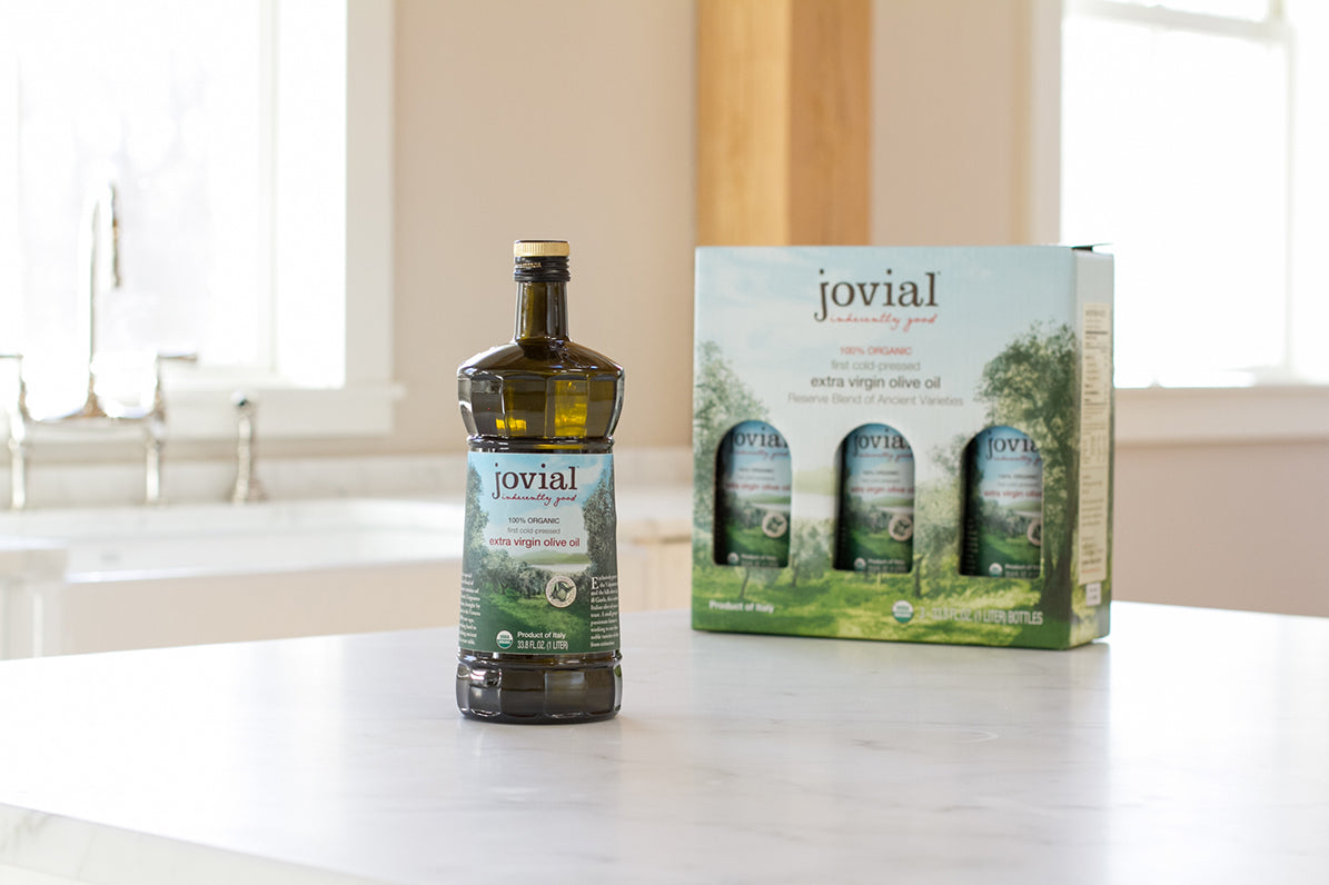 Jovial extra virgin olive oil bottle with boxed three-pack on a bright kitchen counter