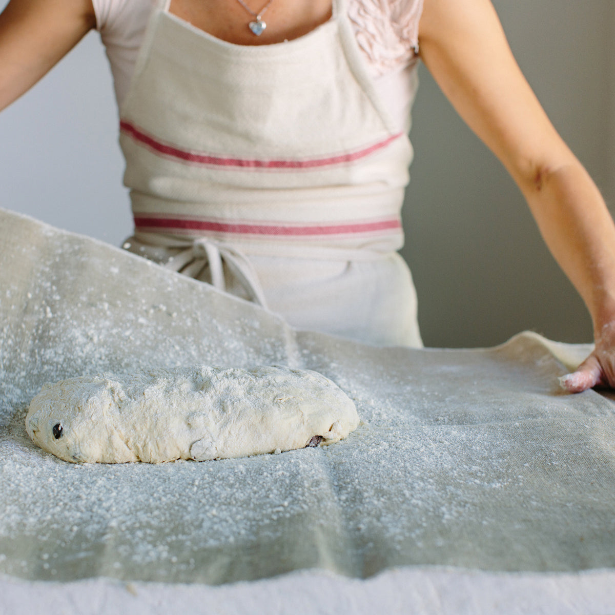 Top view of Jovial linen couche showcasing natural textured linen with soft folds on a light tabletop
