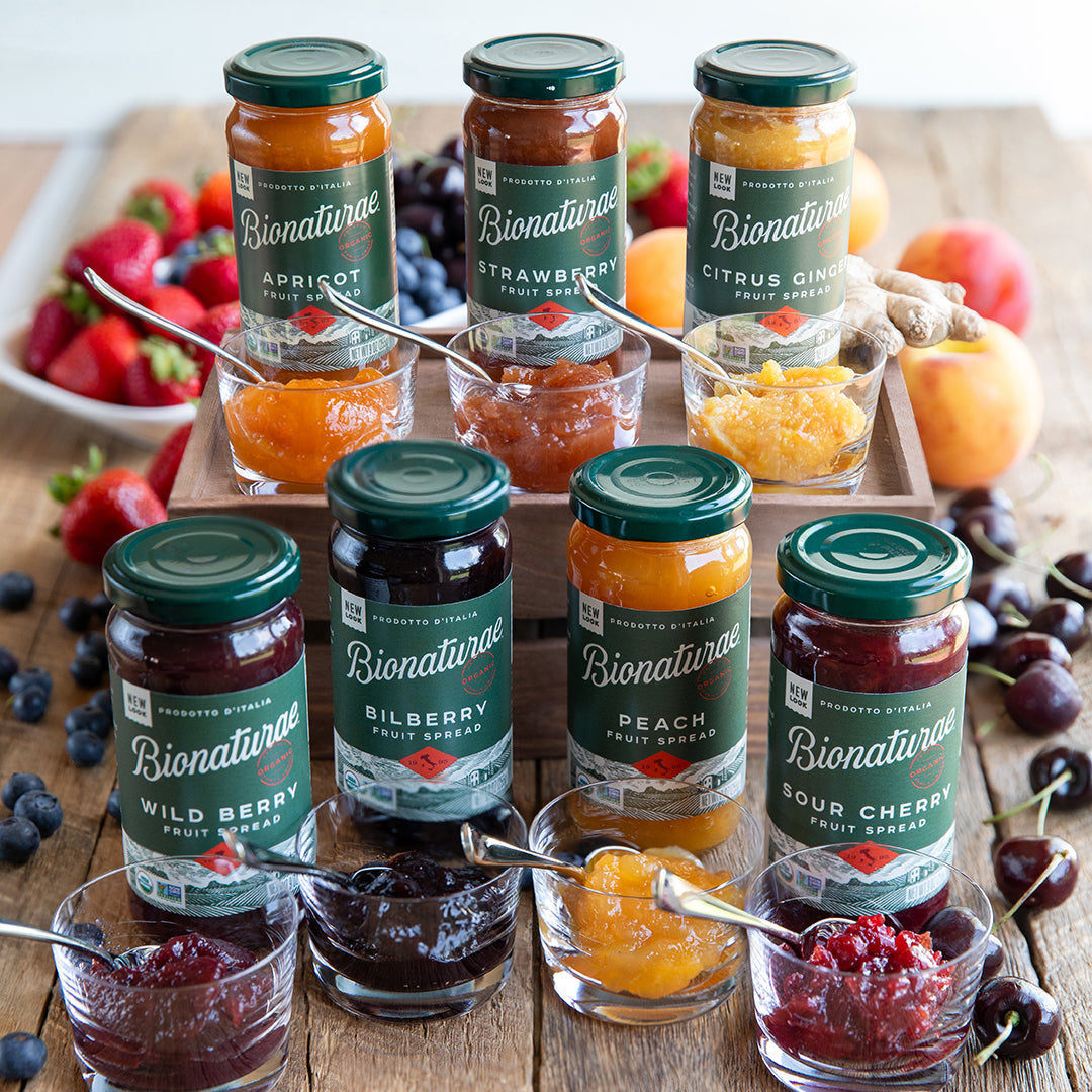 Front view of 9 oz Bionaturae Organic Sour Cherry fruit spread jar showing dark red jam and green label on white background