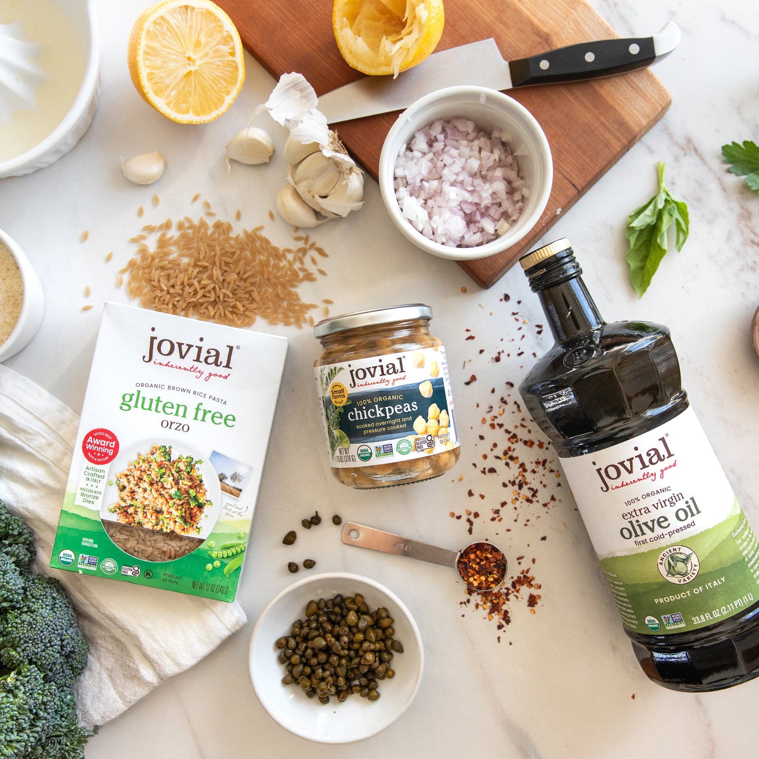 Jovial gluten-free brown rice orzo, jarred chickpeas and olive oil arranged with lemon, garlic and capers