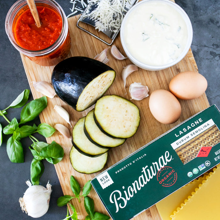 Eggplant lasagna ingredients: sliced eggplant, tomato sauce, ricotta, eggs, garlic, basil, and Bionaturae lasagne box