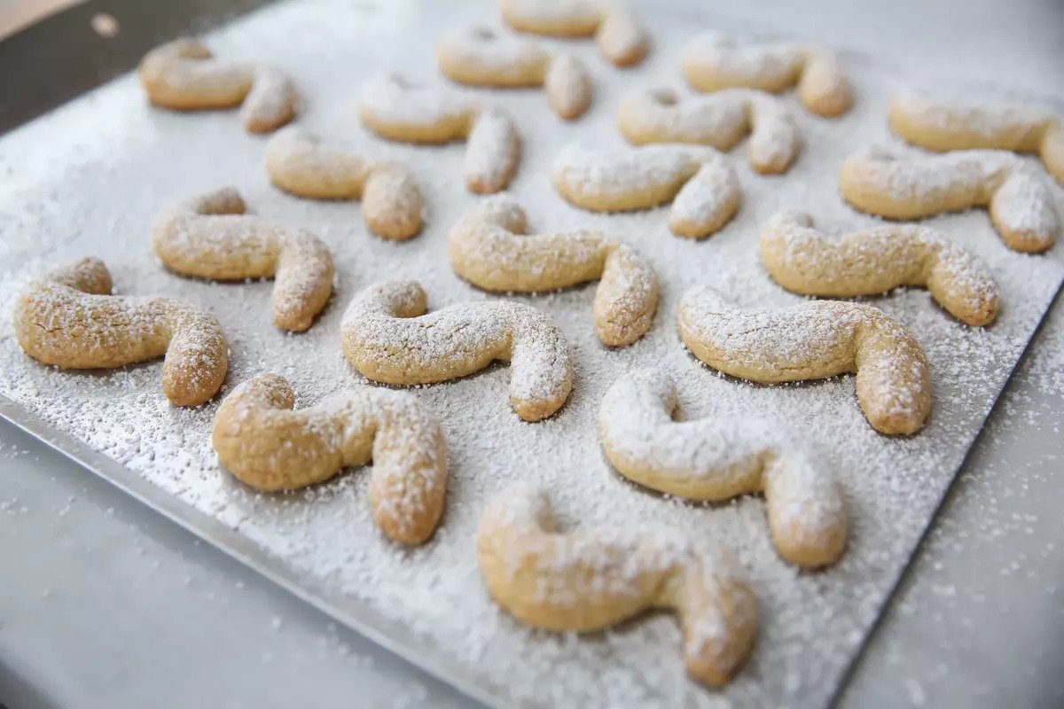 Einkorn Italian shortbread cookies dusted with powdered sugar arranged on a parchment-lined baking sheet