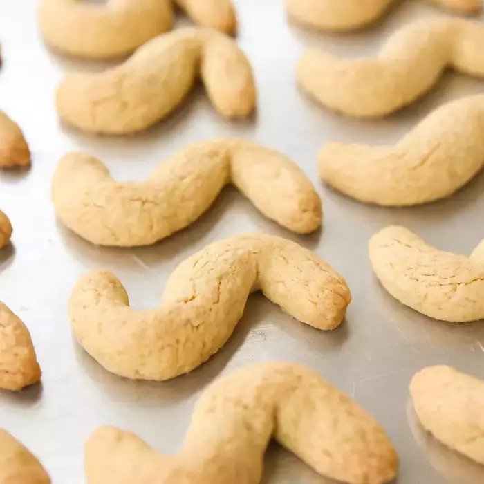 Close-up of einkorn Italian shortbread cookies showcasing their golden, crumbly texture on a baking sheet