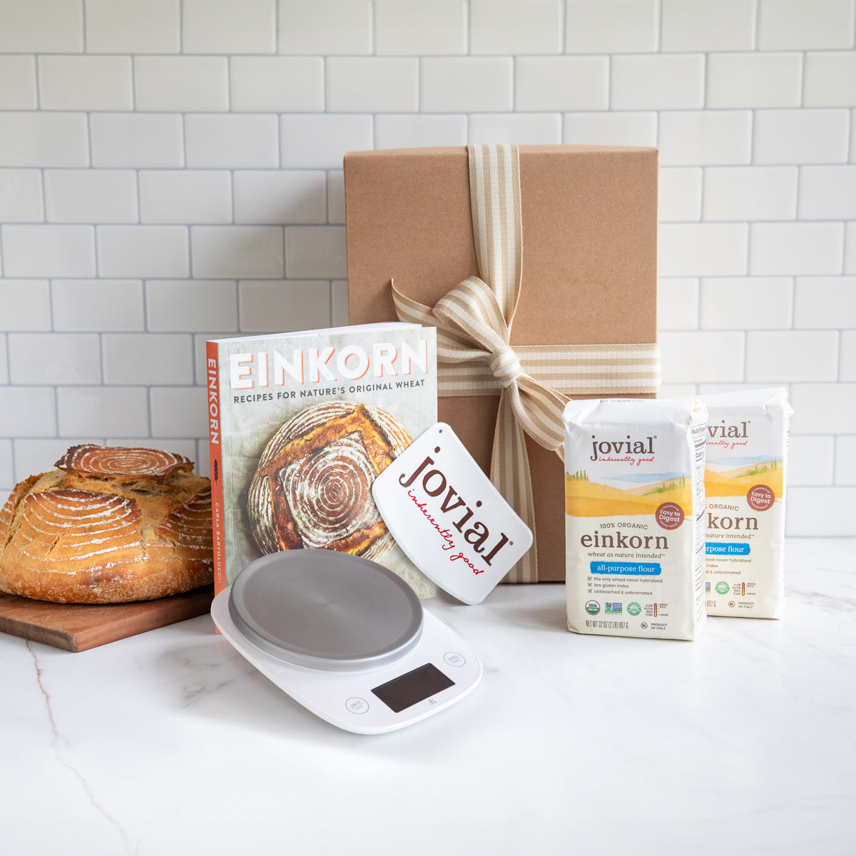 Front view of Beginner Einkorn Baking Kit with two 2 lb bags of einkorn flour, digital baking scale, cookbook, cookbook, and gift box