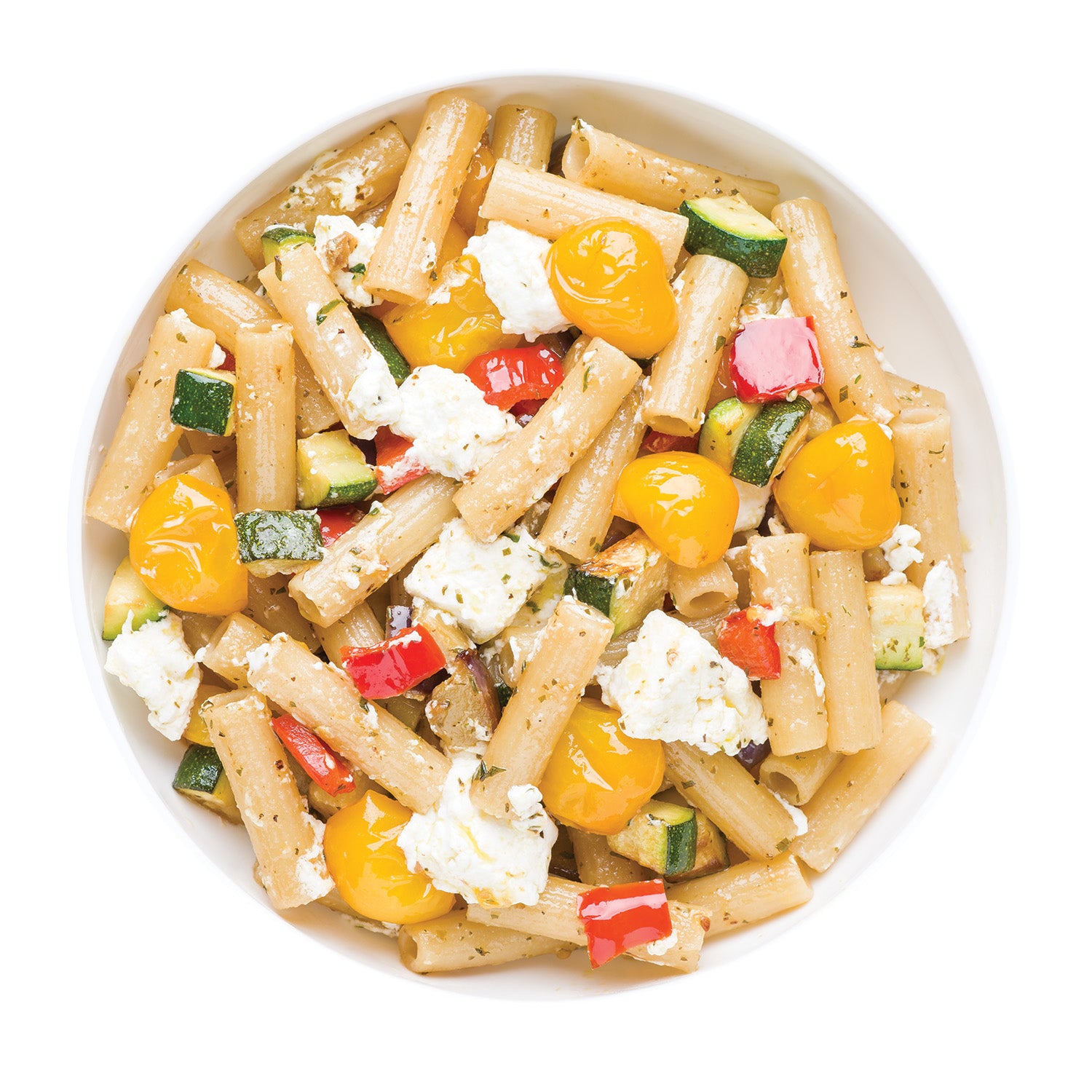 Overhead view of Organic Gluten Free Rice & Lentil Rigatoni with cherry tomatoes, zucchini, and crumbled feta in a white bowl