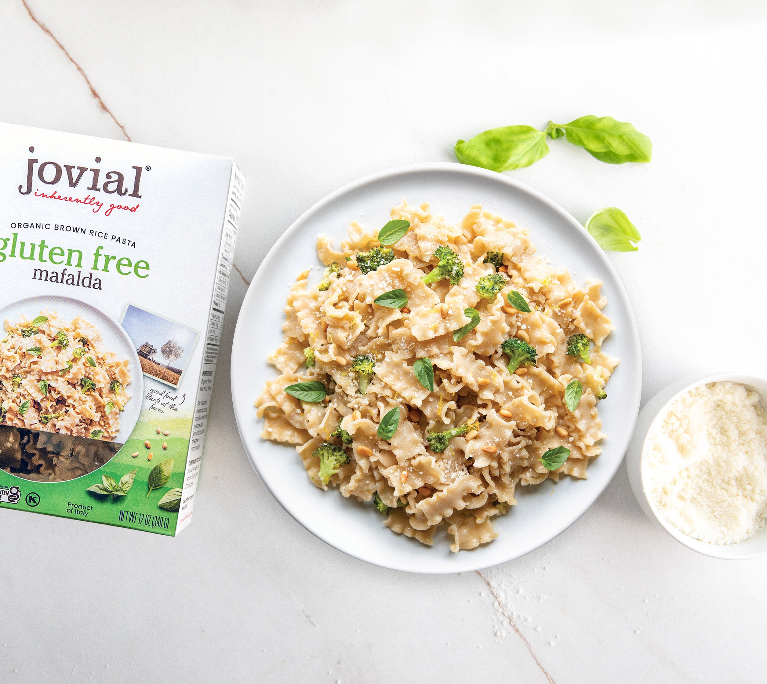 Front view of Organic Gluten Free Brown Rice Mafalda box showing ribbon-shaped brown rice pasta through window on white