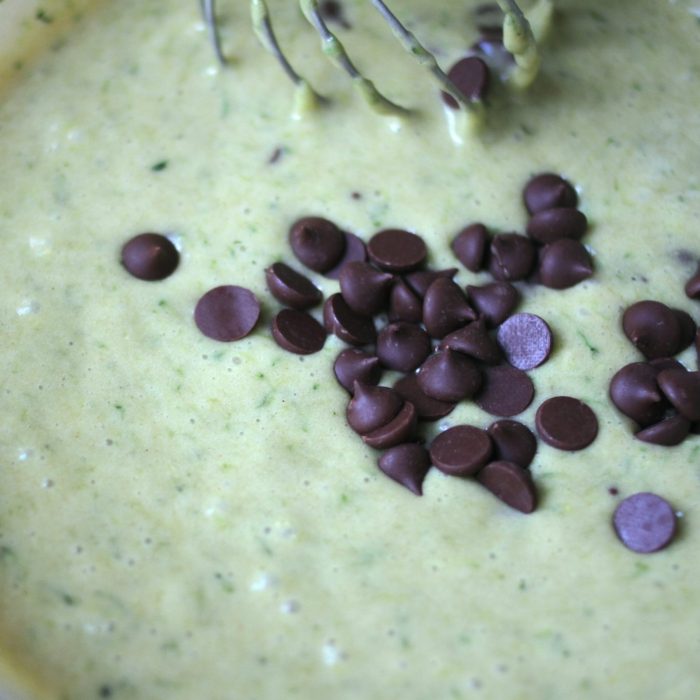 Einkorn zucchini bread batter with chocolate chips being mixed in a bowl