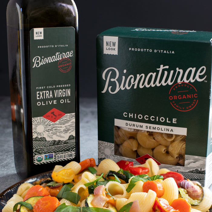 Bionaturae organic extra virgin olive oil and Chiocciole durum semolina pasta with a plate of roasted summer vegetable pasta salad