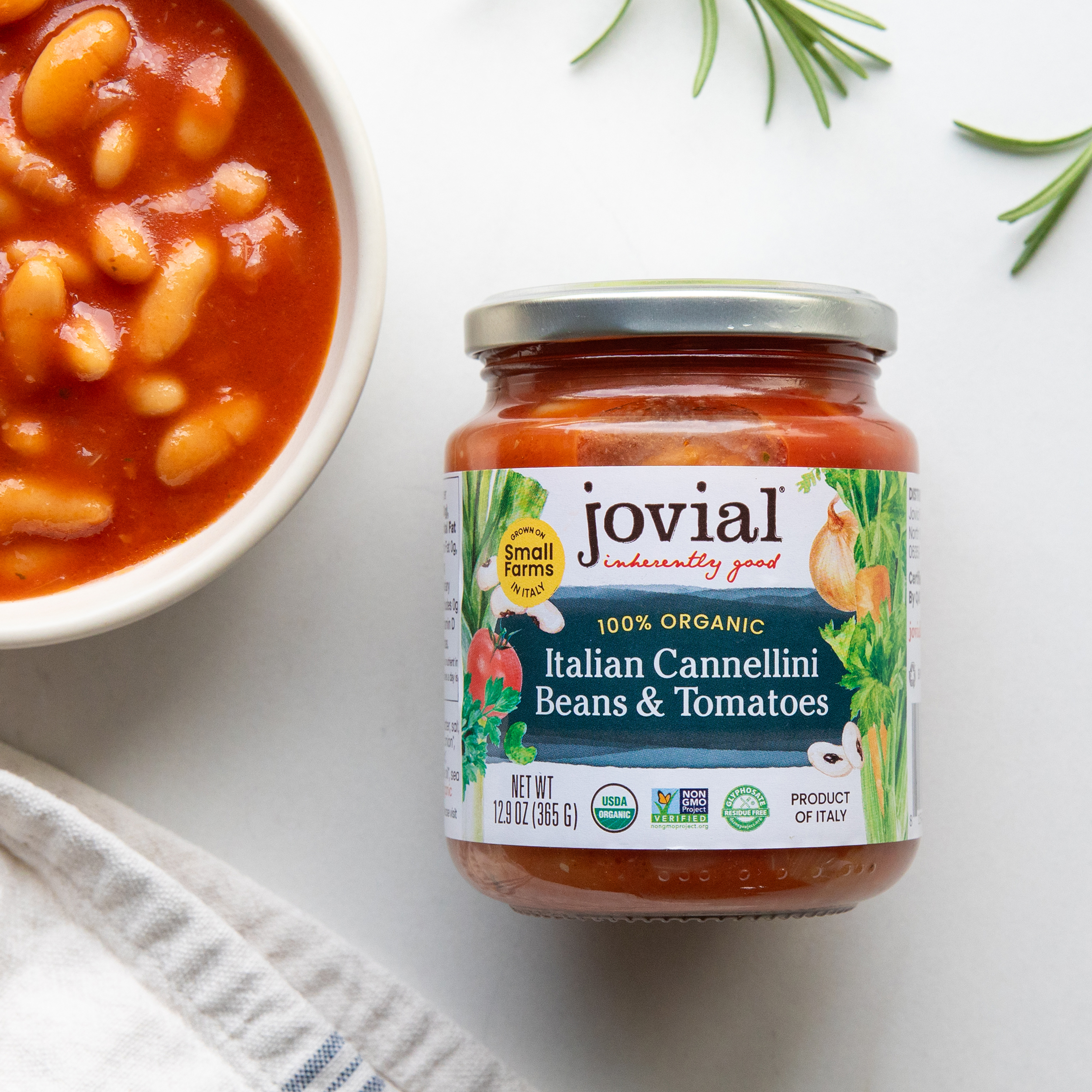 Front view of Jovial jar of Italian cannellini beans and tomatoes showcasing 100 percent organic label on white background