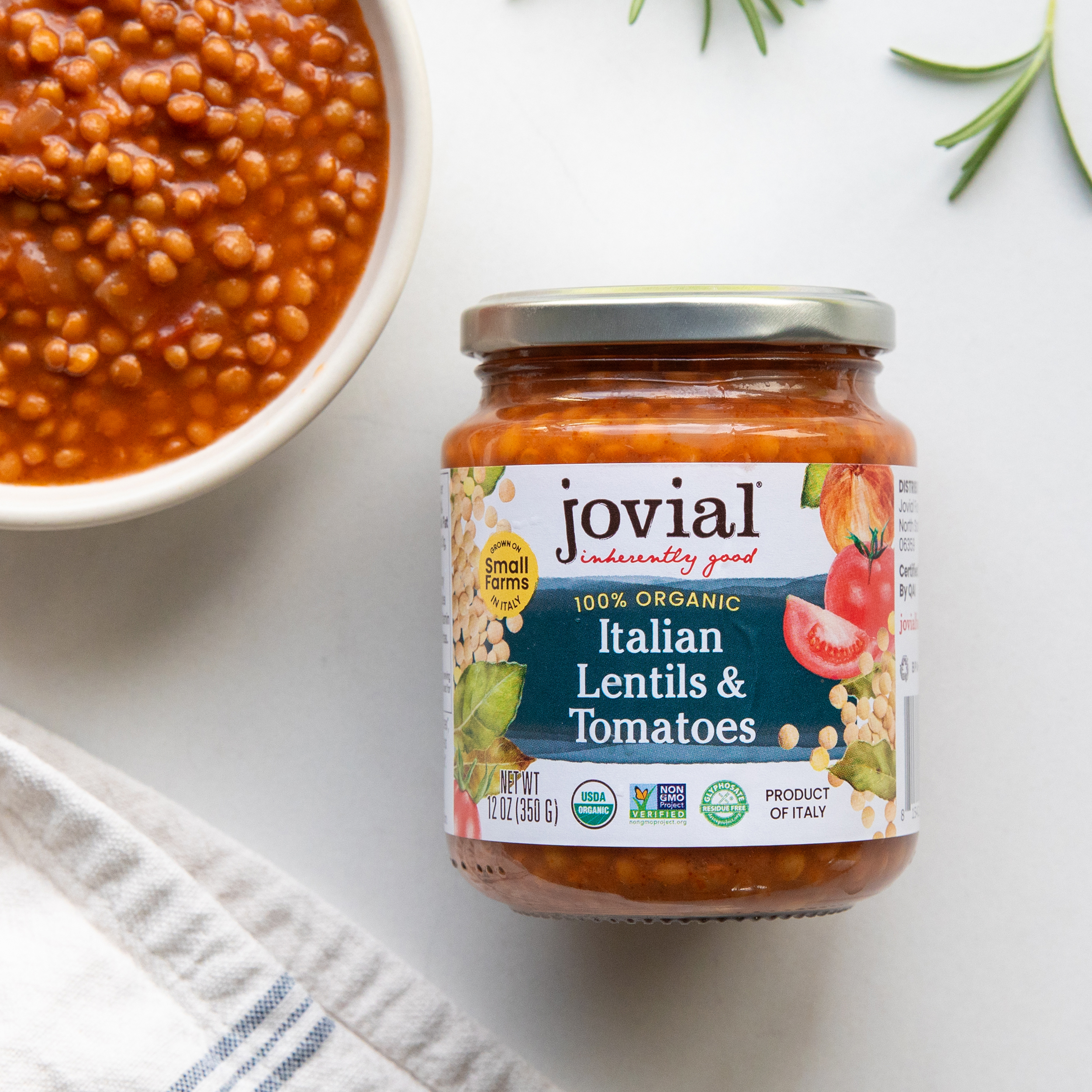 Front view of Jovial Italian Lentils & Tomatoes jar showing 100 percent organic label and bowl on white background