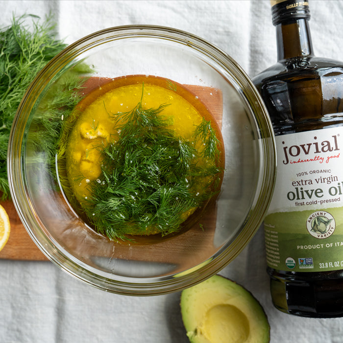 Bowl of dill and lemon dressing made with Jovial Extra Virgin Olive Oil