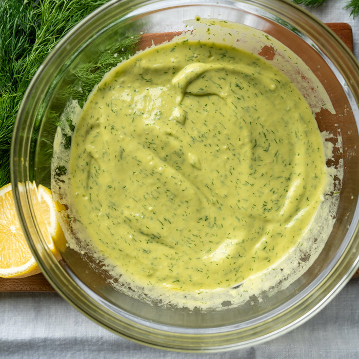 Bowl of dill and lemon dressing made with Jovial Extra Virgin Olive Oil