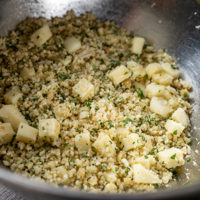 A mixture of einkorn bread crumbs, cheese, and herbs