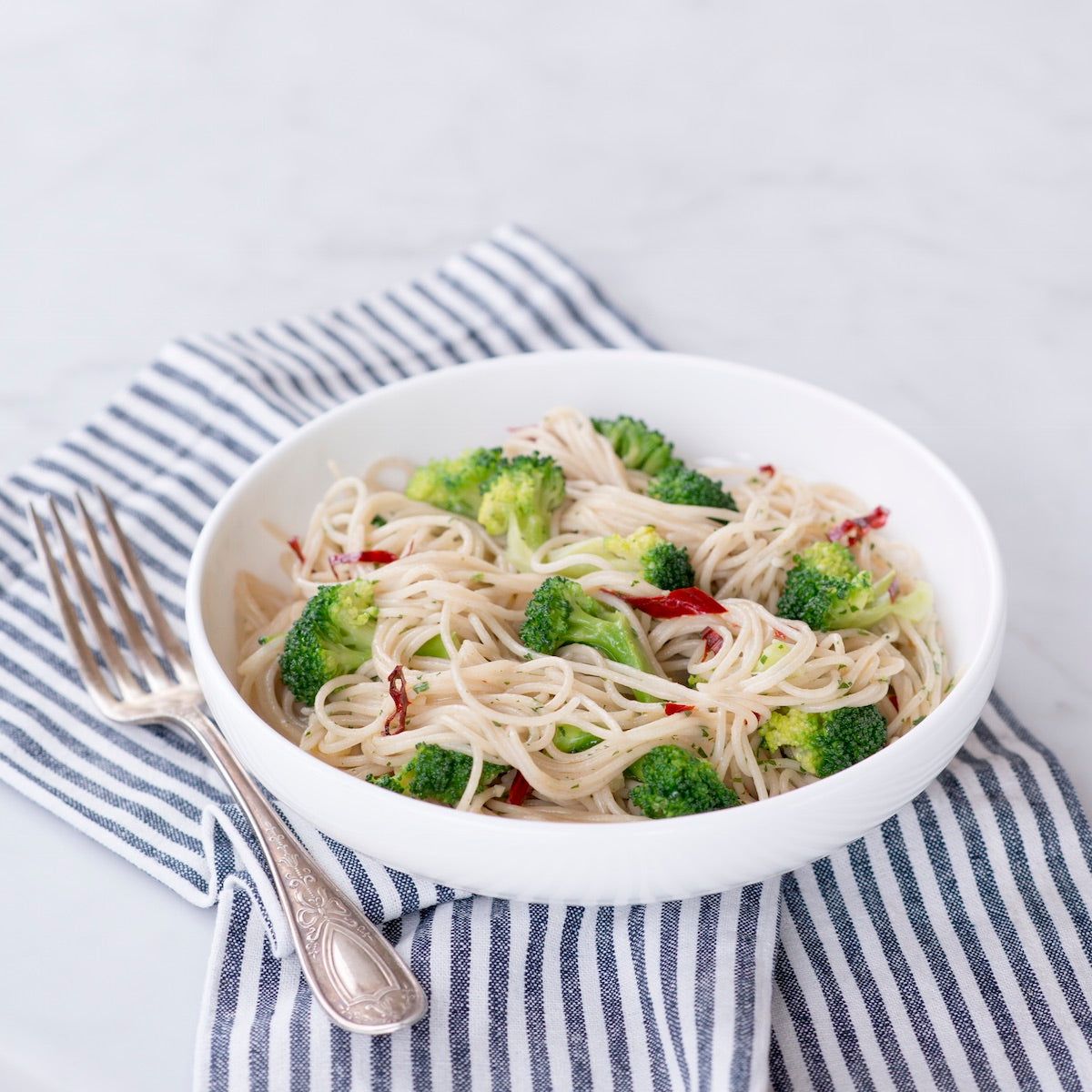 Front view of 12 oz box of organic brown rice capellini showing Regenerative Organic Certified label on white background