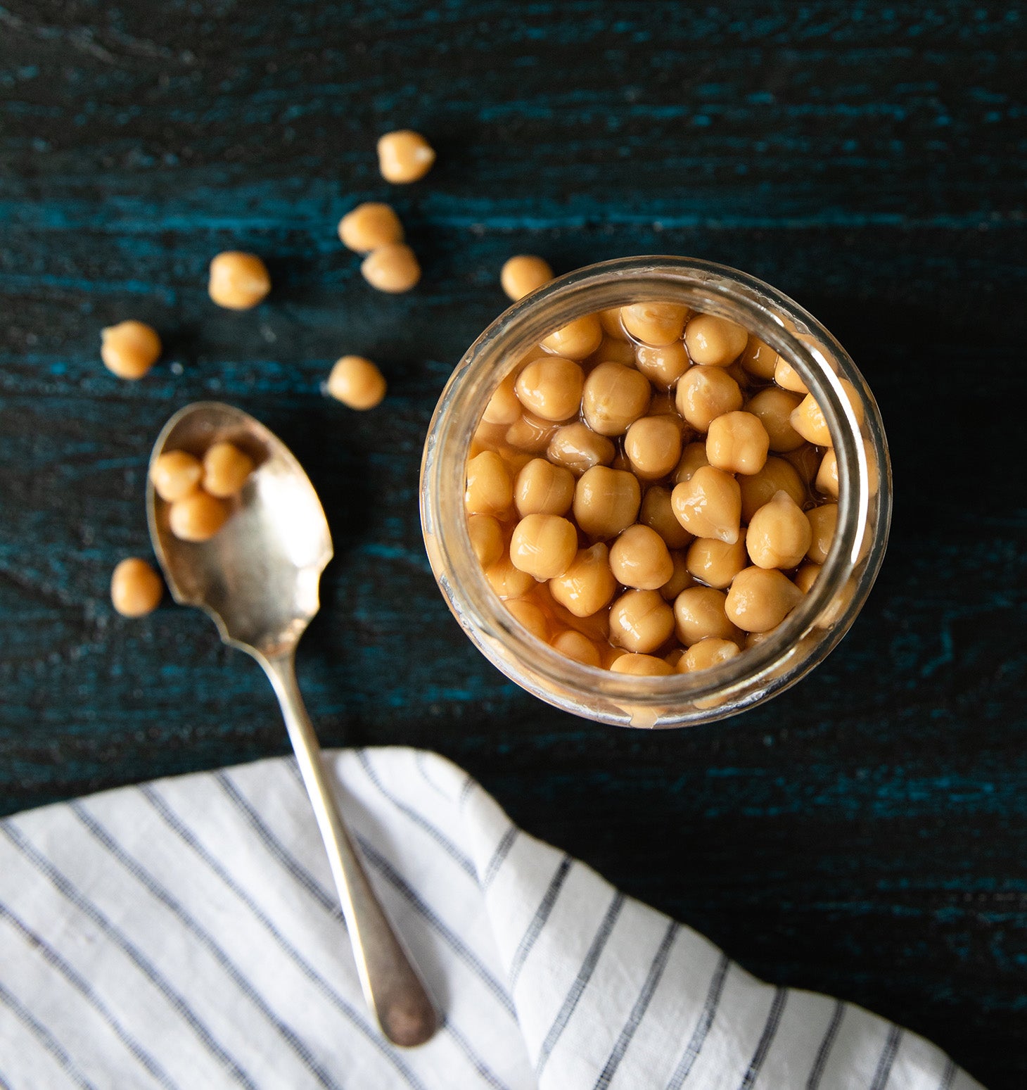 Infographic showing nutrition highlights for Organic Chickpeas: 9g protein and 5g fiber per serving, only sea salt added