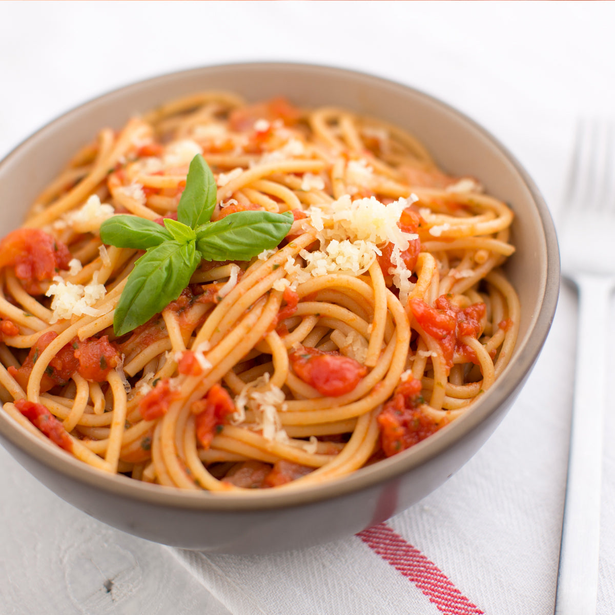 Front view of Organic Einkorn Traditional Spaghetti package showcasing front label and uncooked spaghetti strands on white background