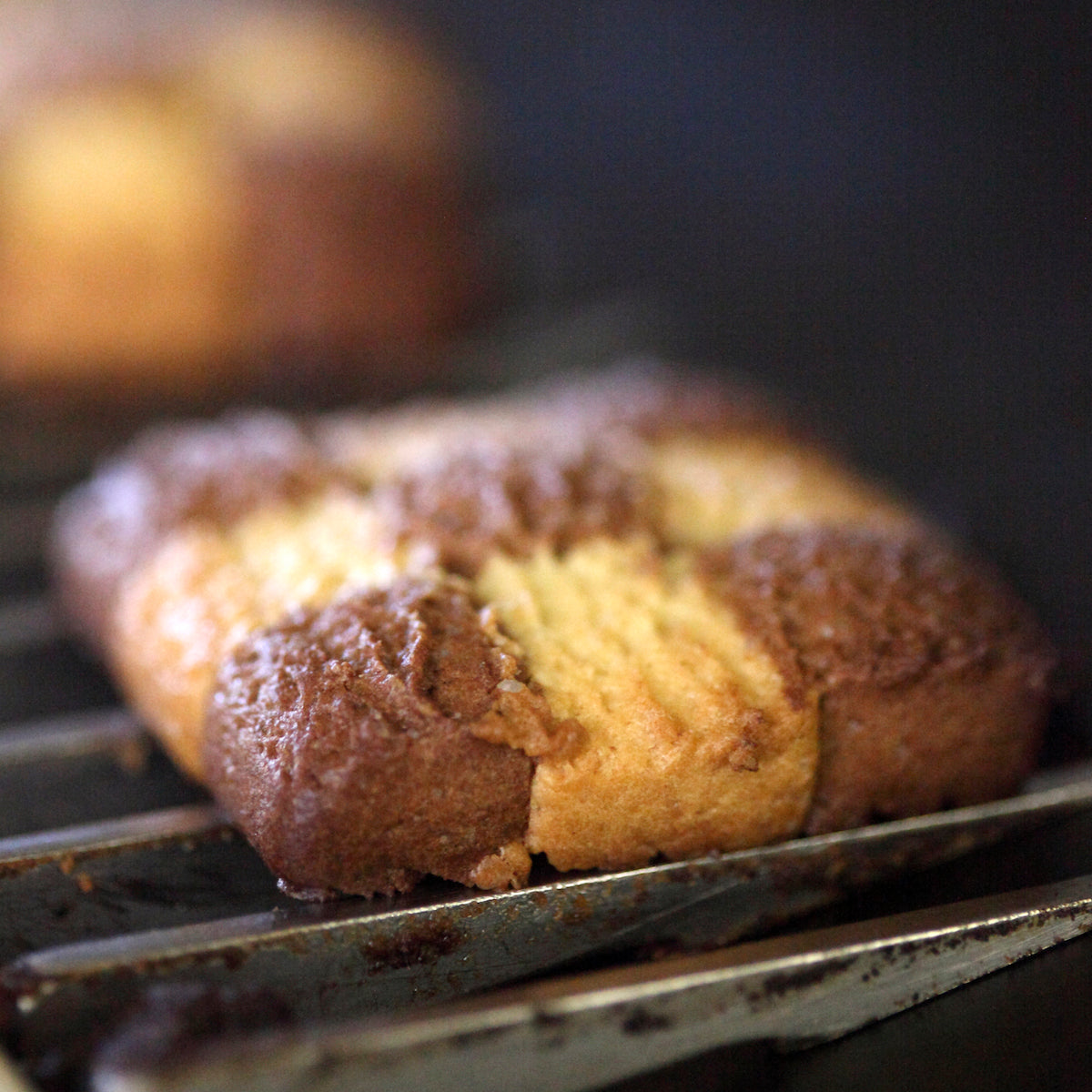 Close-up of Organic Einkorn checkerboard cookies showcasing chocolate and vanilla shortbread squares on a cooling rack