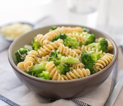 Close-up of Organic Einkorn Traditional Fusilli showing cooked spiral pasta with broccoli in a ceramic bowl