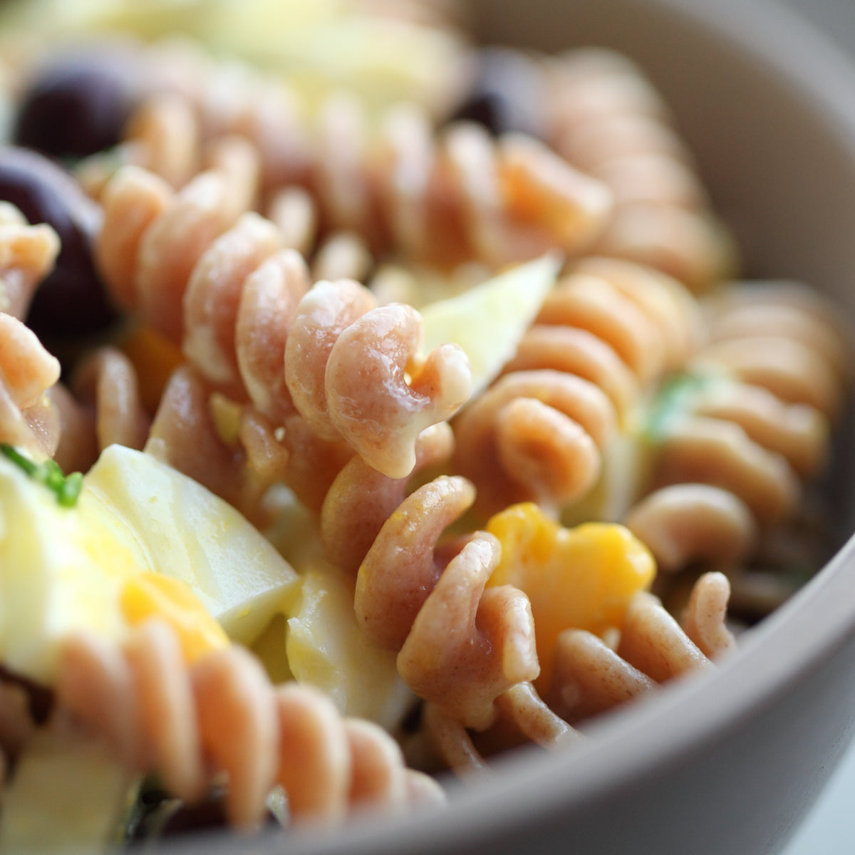 Close-up of cooked Organic Einkorn Whole Wheat Fusilli showcasing spiral shape and whole-grain texture in a ceramic bowl