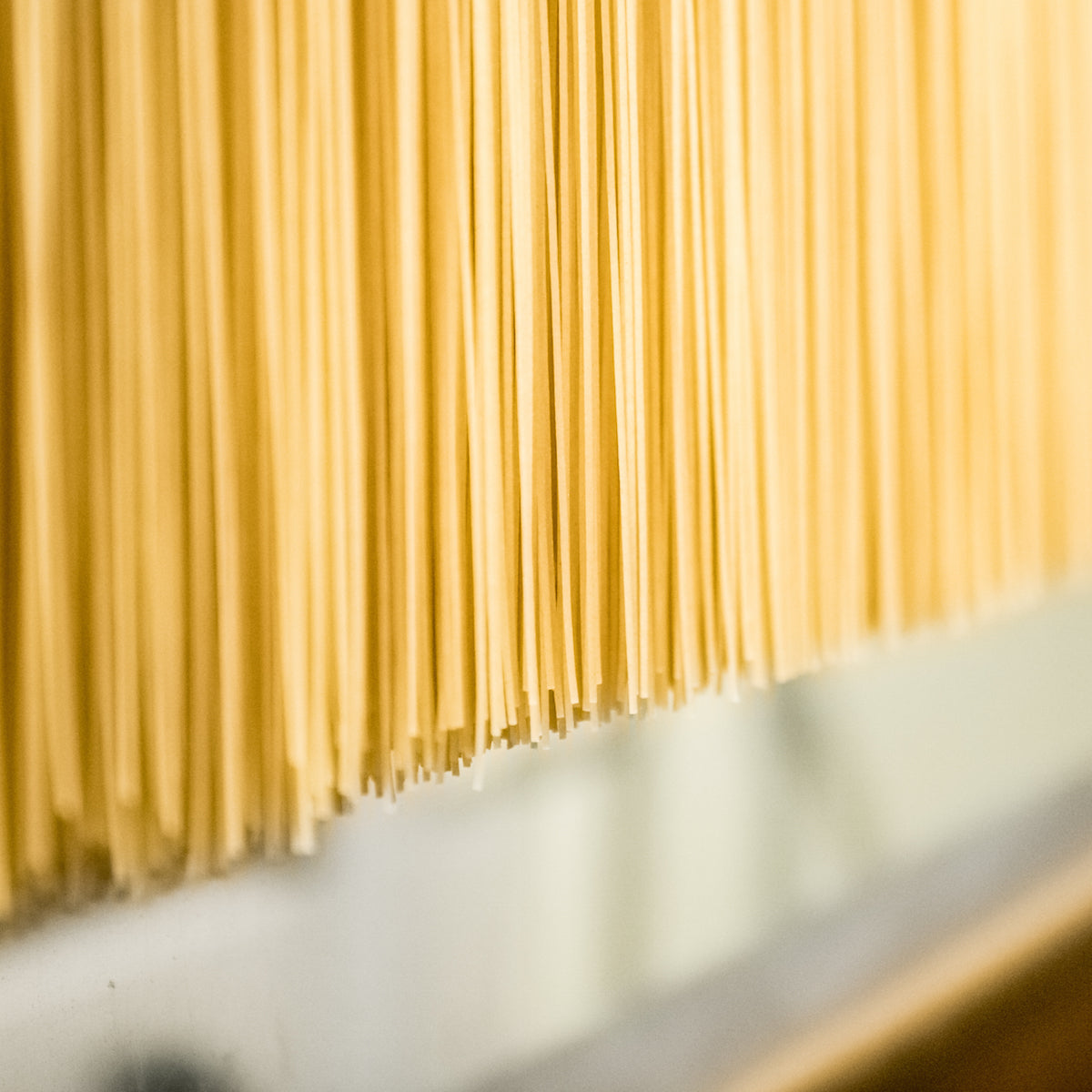 Front view of Organic Gluten Free Brown Rice Fettuccine package showcasing brown rice fettuccine strands on white background