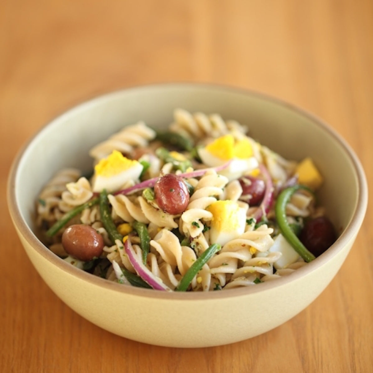 Close-up of organic gluten free brown rice fusilli pasta showing spiral shape and rough texture on white background