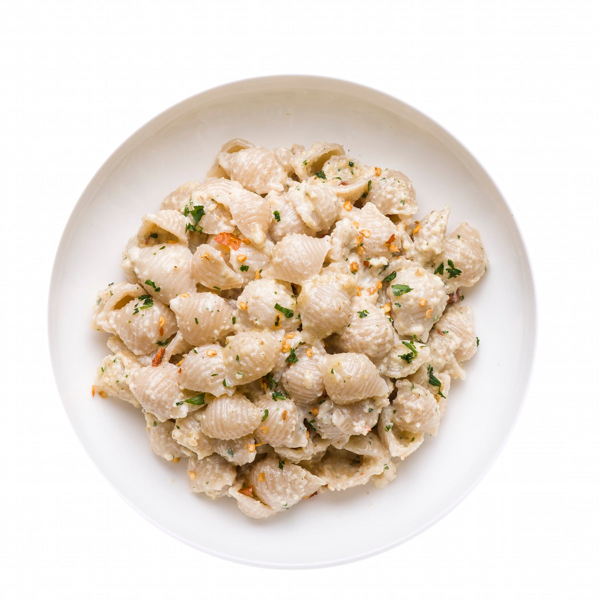 Top-down view of cooked Organic Gluten Free Brown Rice Shells showcasing shell shape and texture on a white background