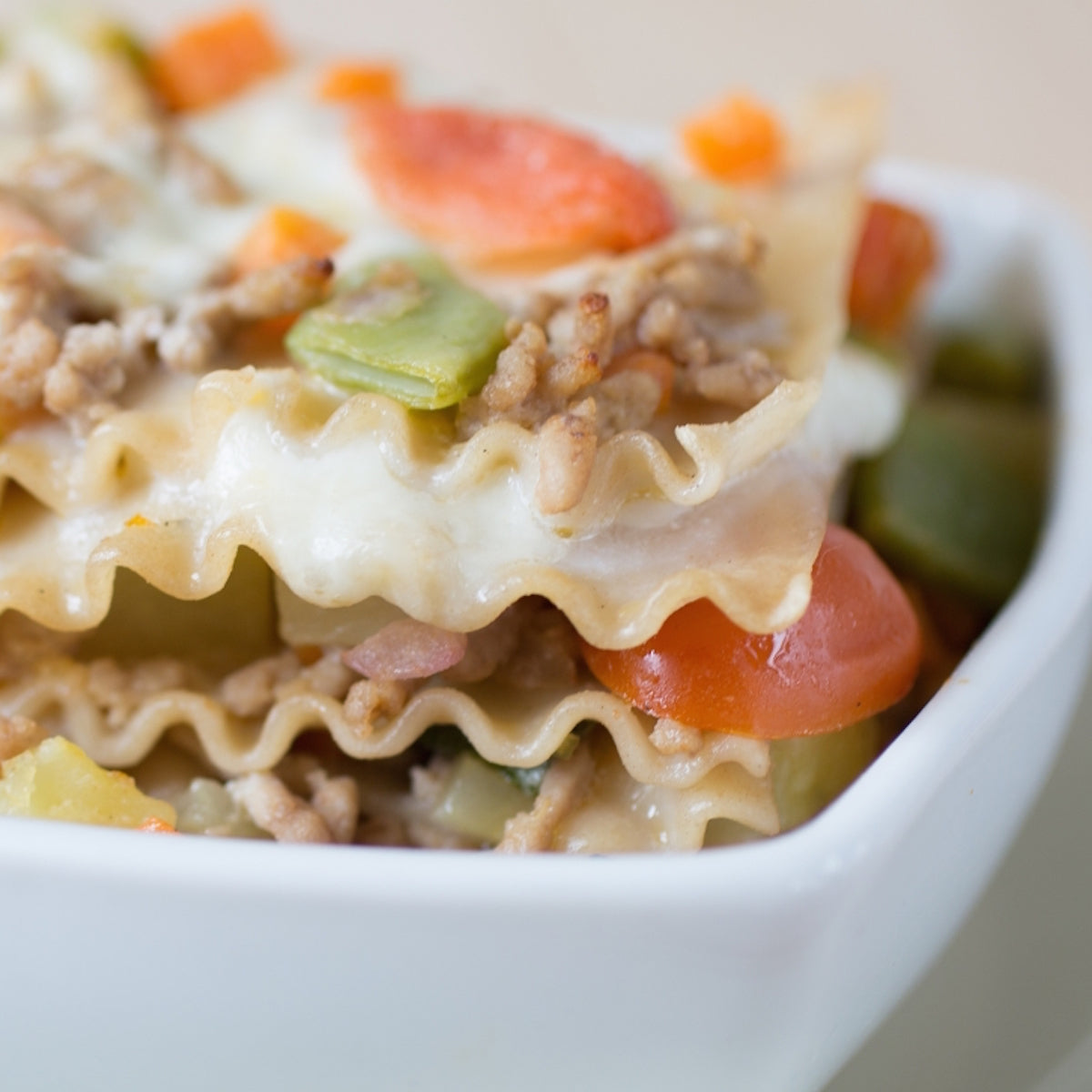 Cooked organic gluten-free brown rice lasagna served in a white baking dish