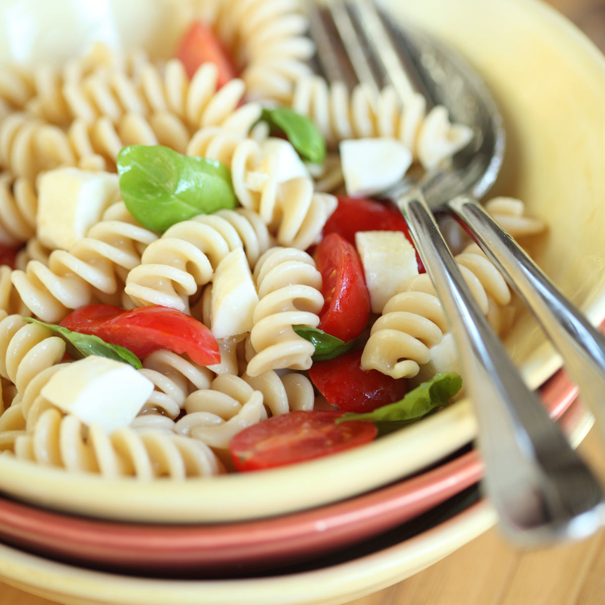 Close-up of Organic Einkorn fusilli showing spiral shape and whole-grain texture on white background