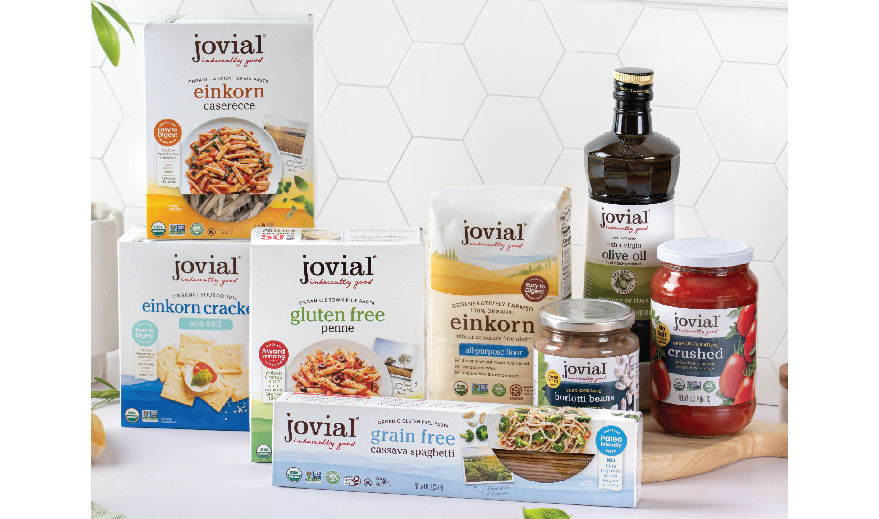 Front view of Jovial pantry products: einkorn pasta and flour, olive oil, jarred tomatoes and beans on a counter