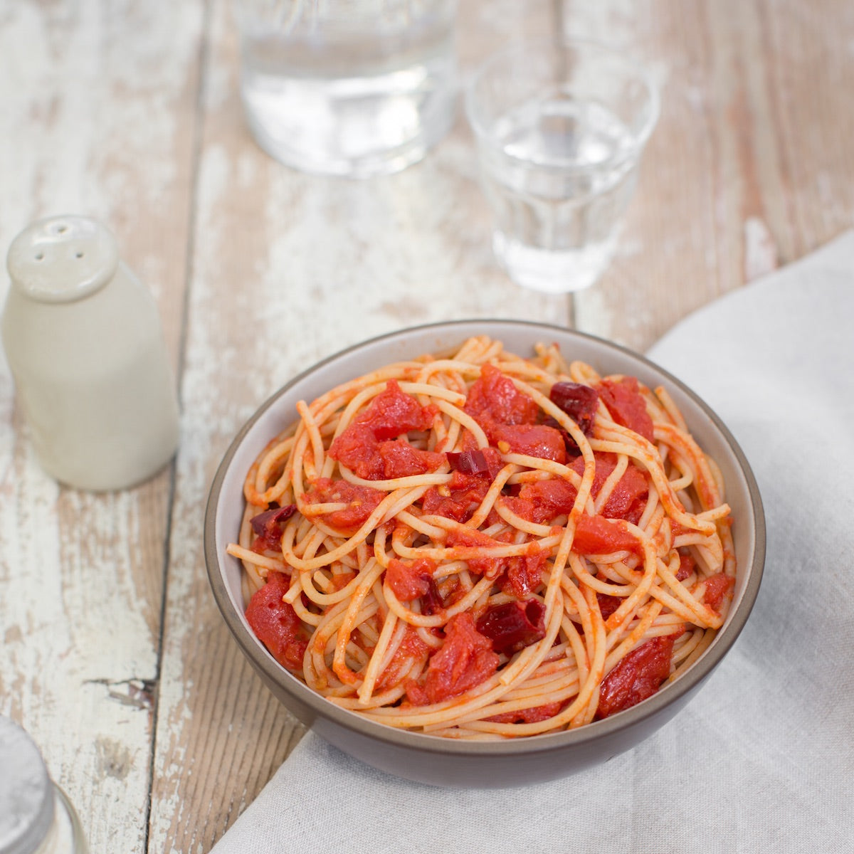 Close-up of Organic Einkorn Traditional Spaghetti showcasing thin strands and texture on a neutral background