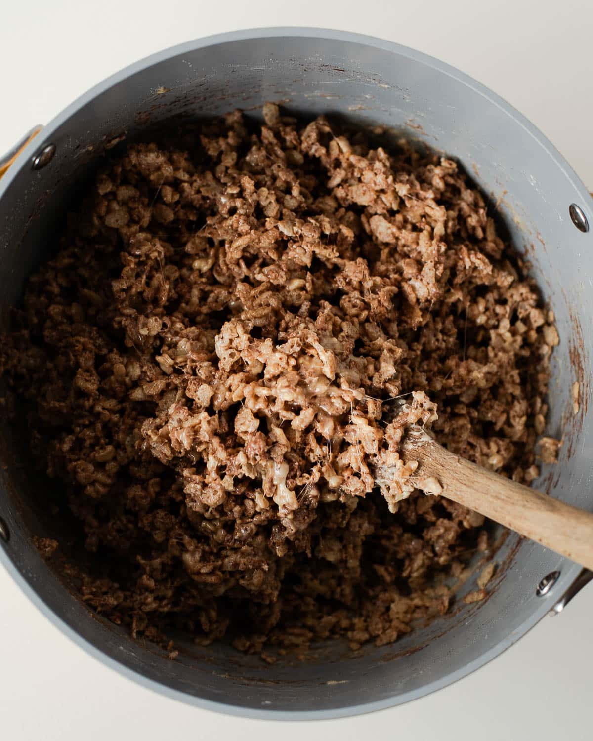 Cocoa-peanut butter Rice Krispie cereal mixture fully combined in a pot, ready to shape into turkey legs.