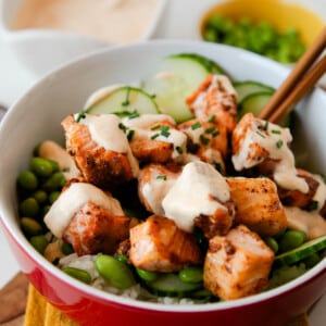 crispy salmon bowl with bang bang sauce drizzled on it