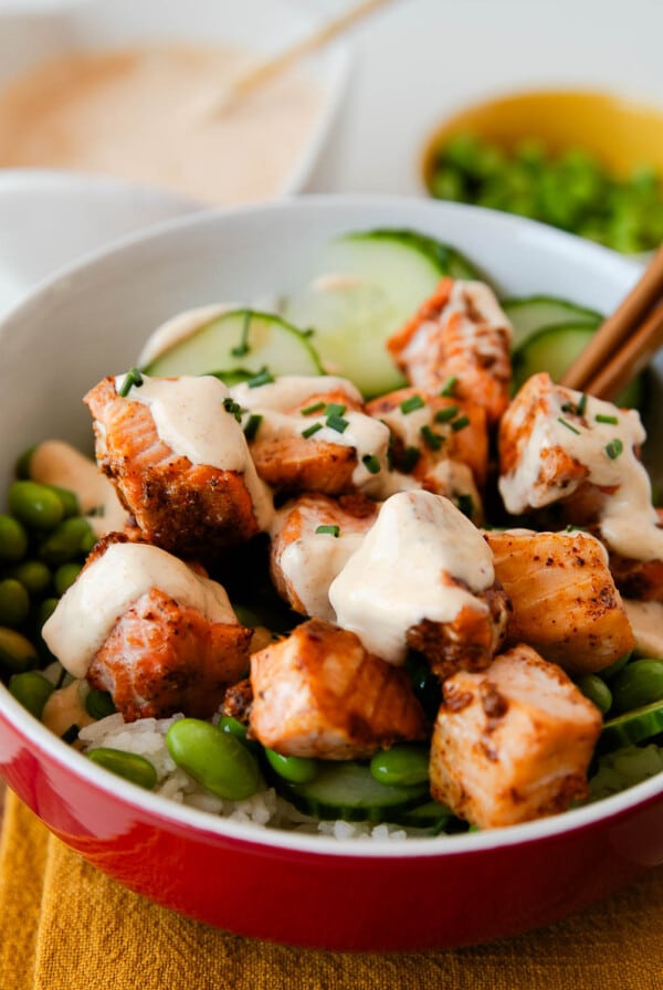 crispy salmon bowl with bang bang sauce drizzled on it