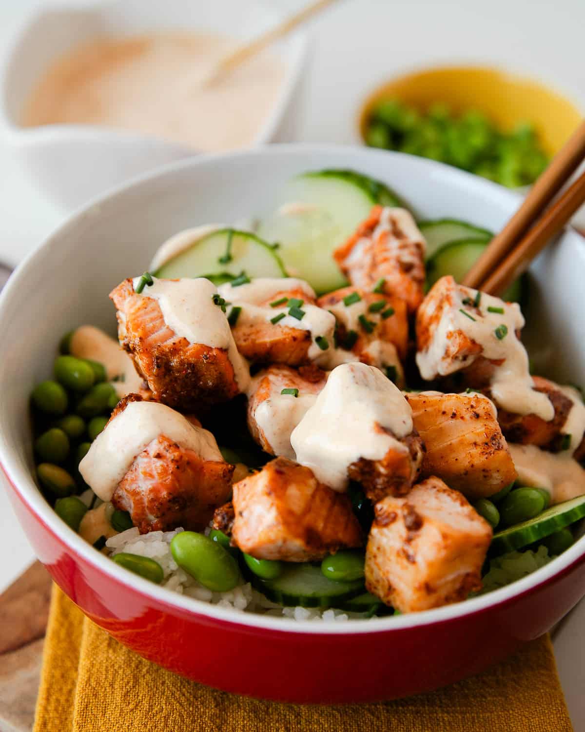 crispy salmon bowl with bang bang sauce drizzled on it