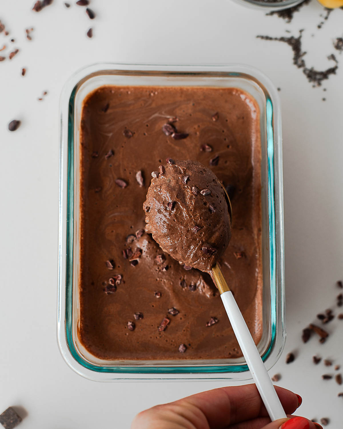 Spoon lifting thick, creamy chocolate protein chia pudding to show set texture.