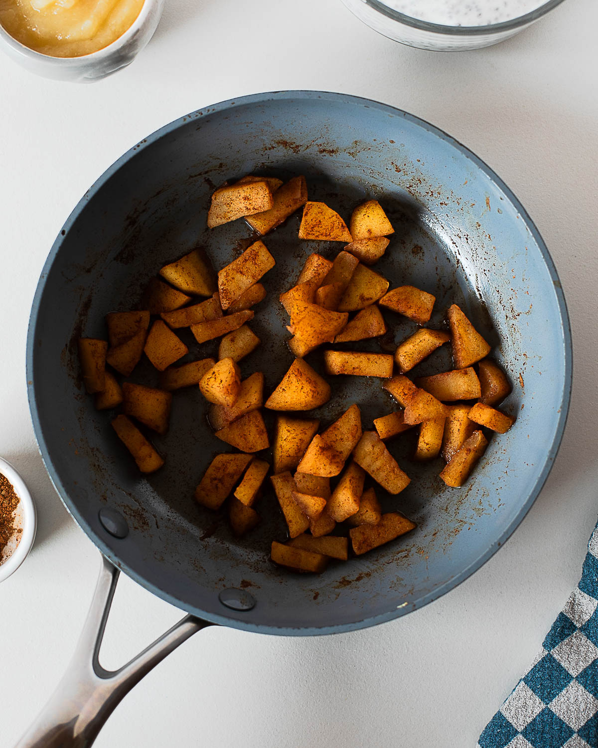 Cinnamon sautéed apples cooking in a skillet for apple pie chia pudding topping