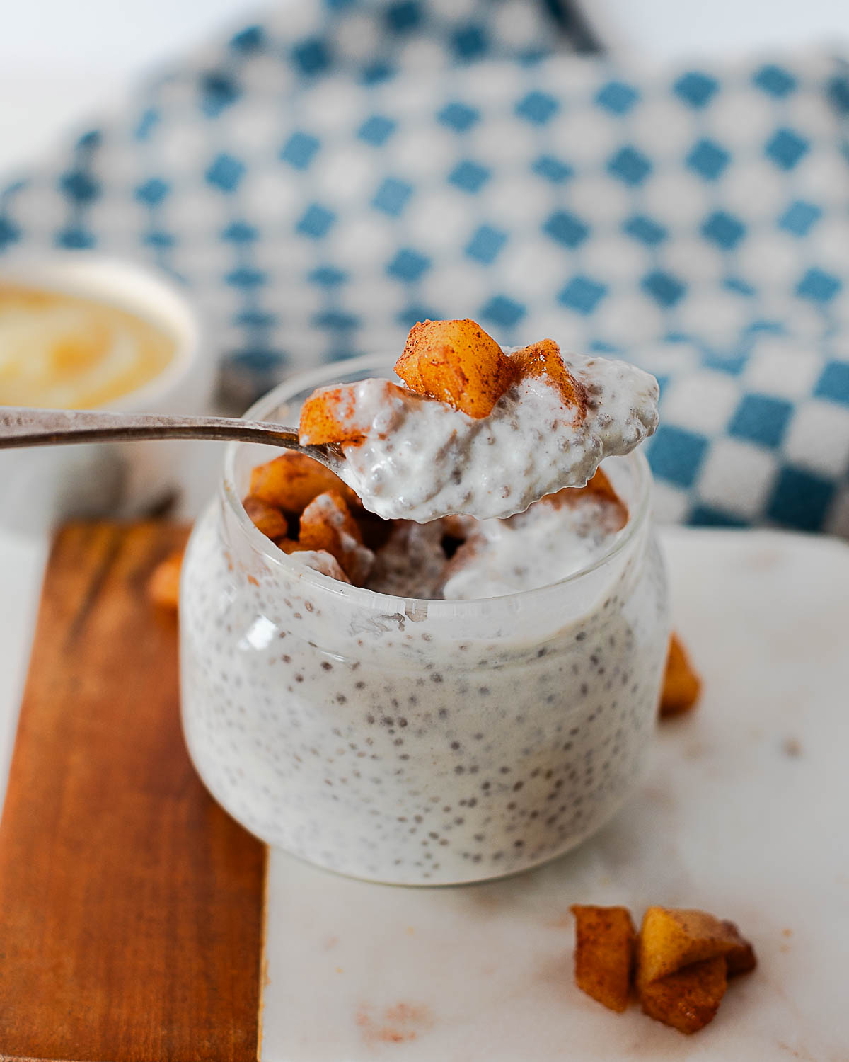 Spoonful of apple pie chia pudding showing creamy texture and chia seeds