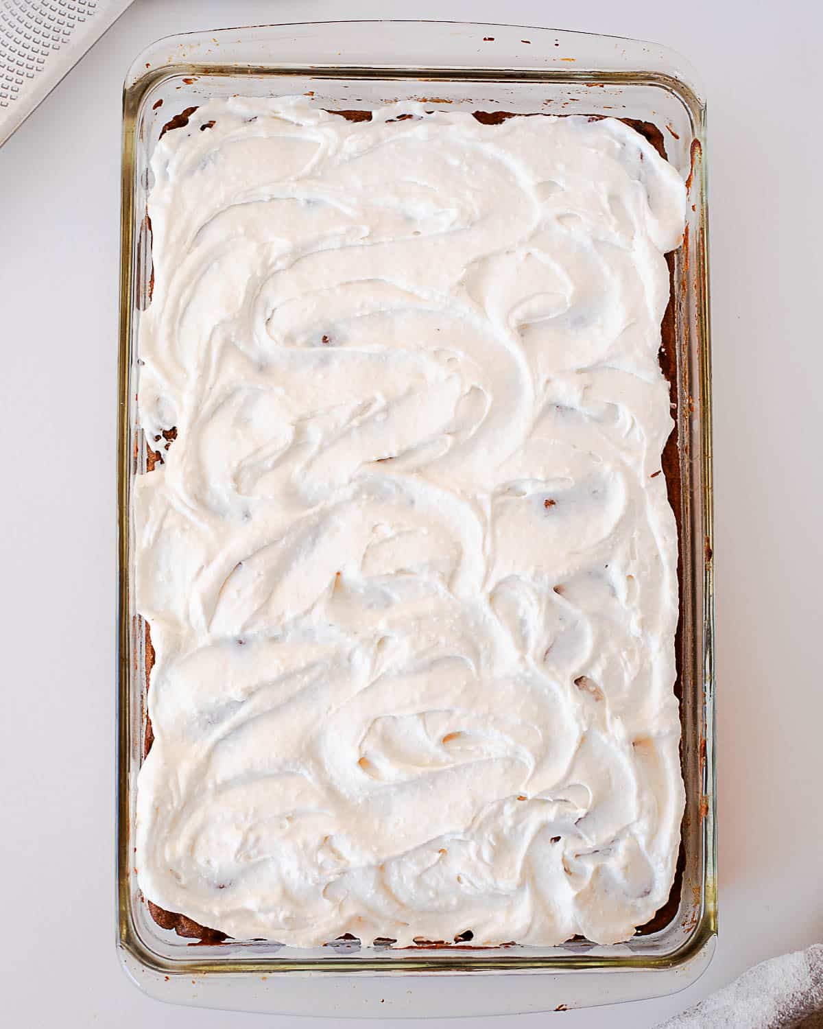 Pumpkin chocolate chip bars topped with an even layer of cream cheese frosting